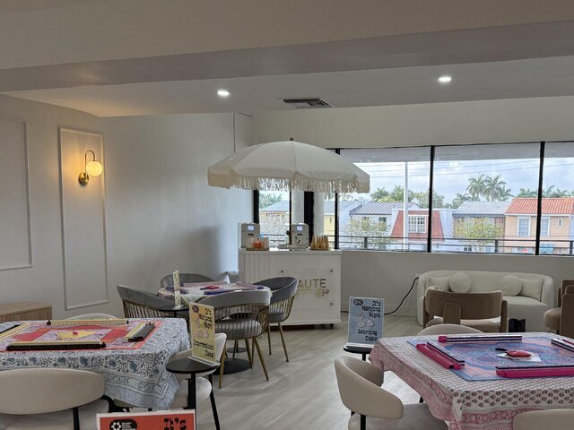 A white Bash soft serve station with a fringed umbrella set up in a bright event lounge